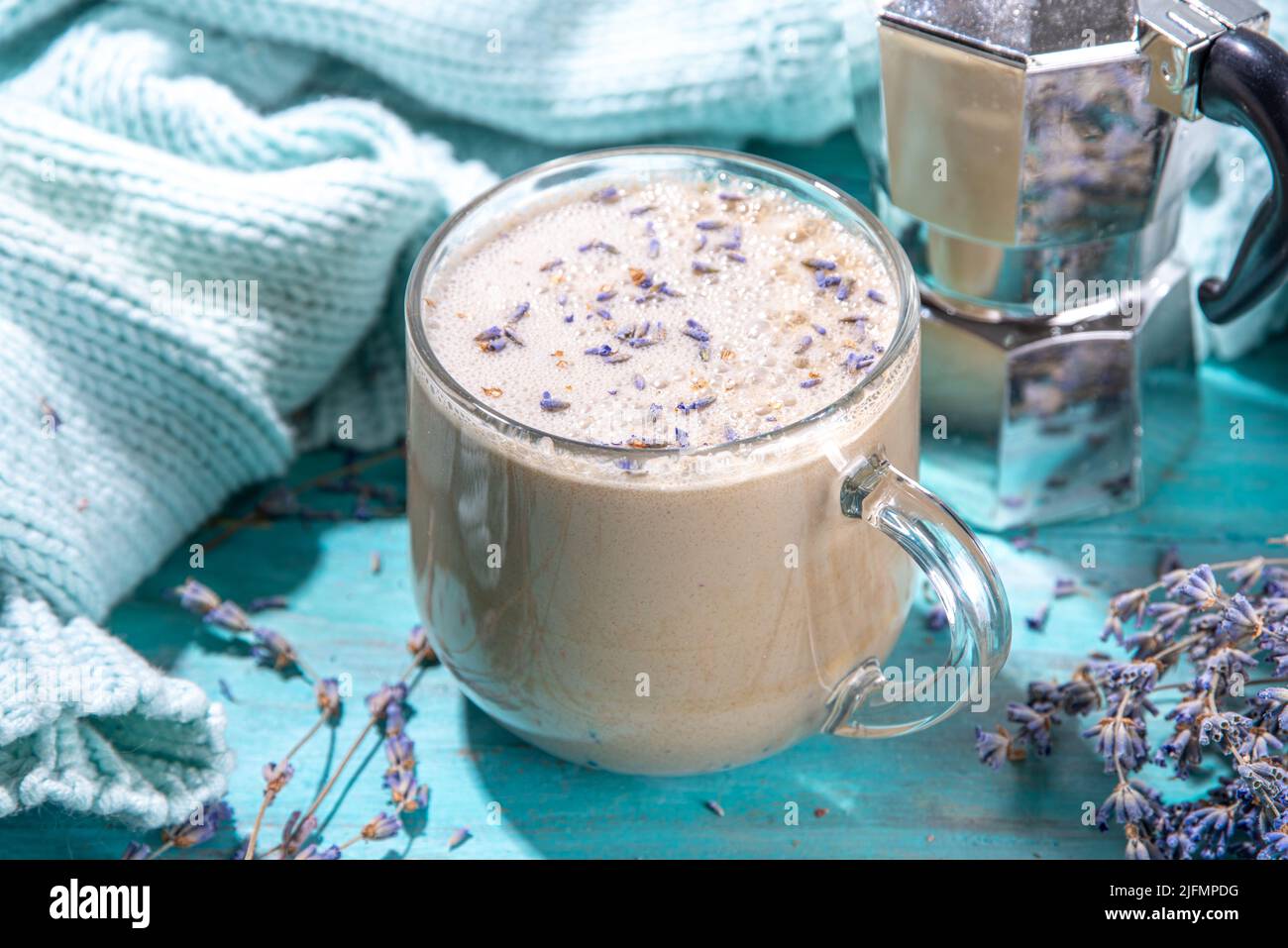 https://c8.alamy.com/comp/2JFMPDG/cup-of-cappuccino-raf-coffee-with-lavender-syrup-aromatic-lavandula-infused-latte-coffee-hot-drink-on-blue-wood-table-copy-space-2JFMPDG.jpg