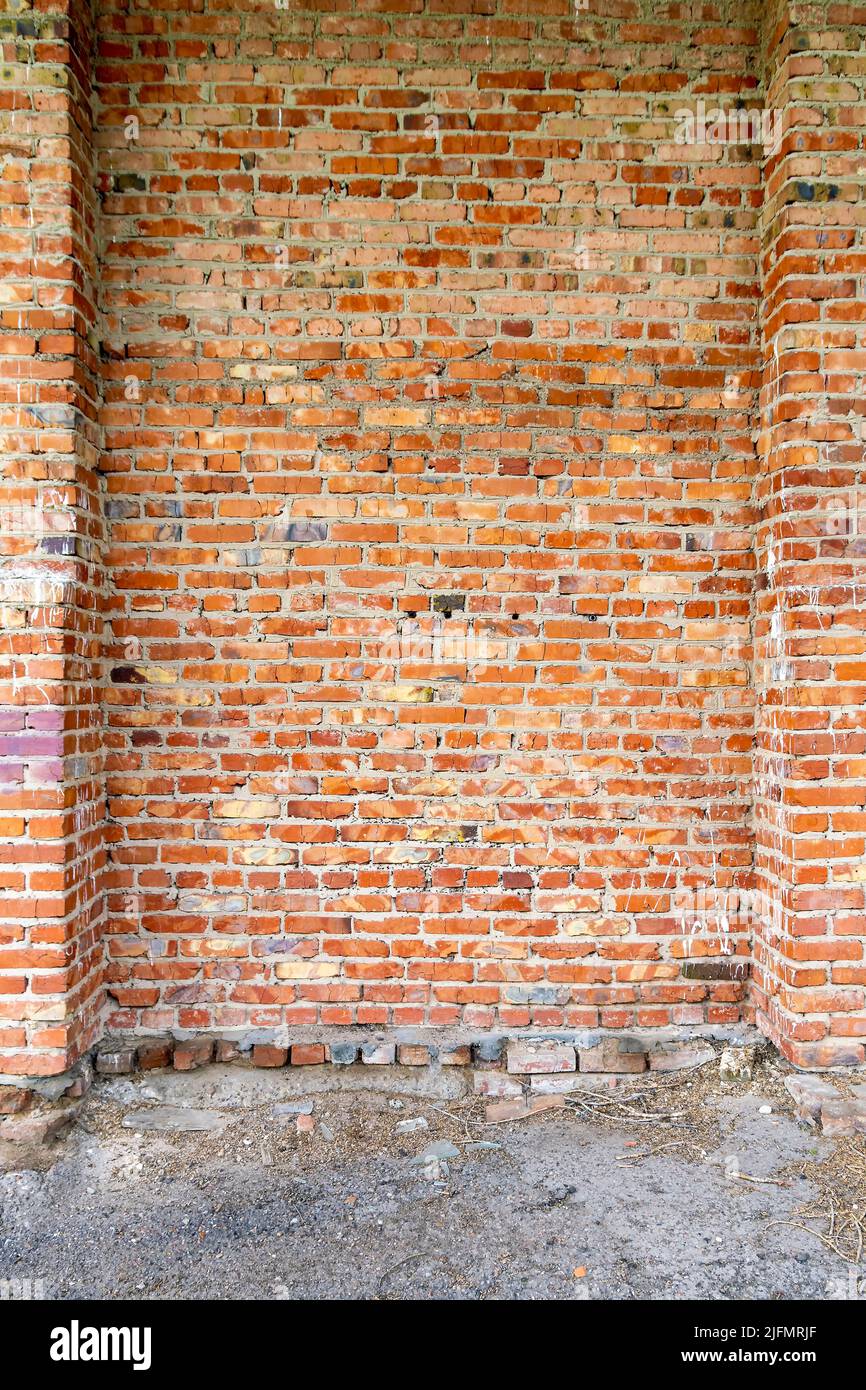 Vertical texture surface of an old weathered red brick building wall ...