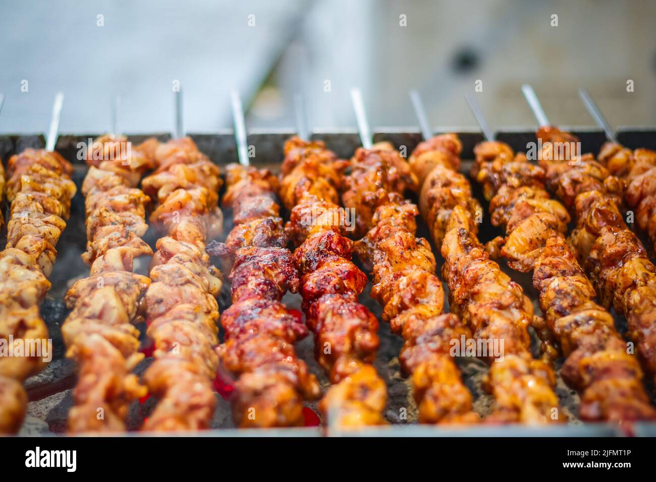 Chicken kebabs cooking on a charcoal grill at Christmas market Hyde
