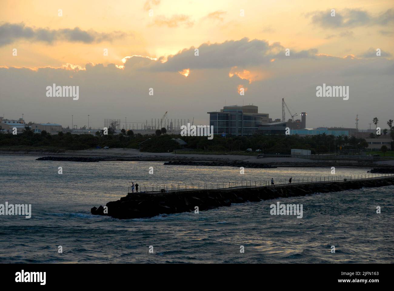 Industrial landscape seen leaving Fort Lauderdale, Florida, USA by sea with people on a jetty Stock Photo