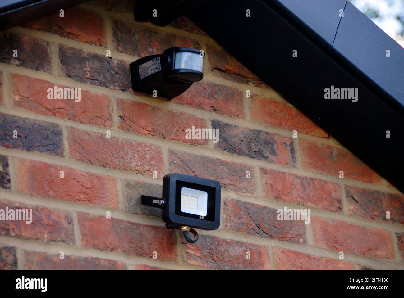 Security light with sensor above garage door of domestic house Stock Photo
