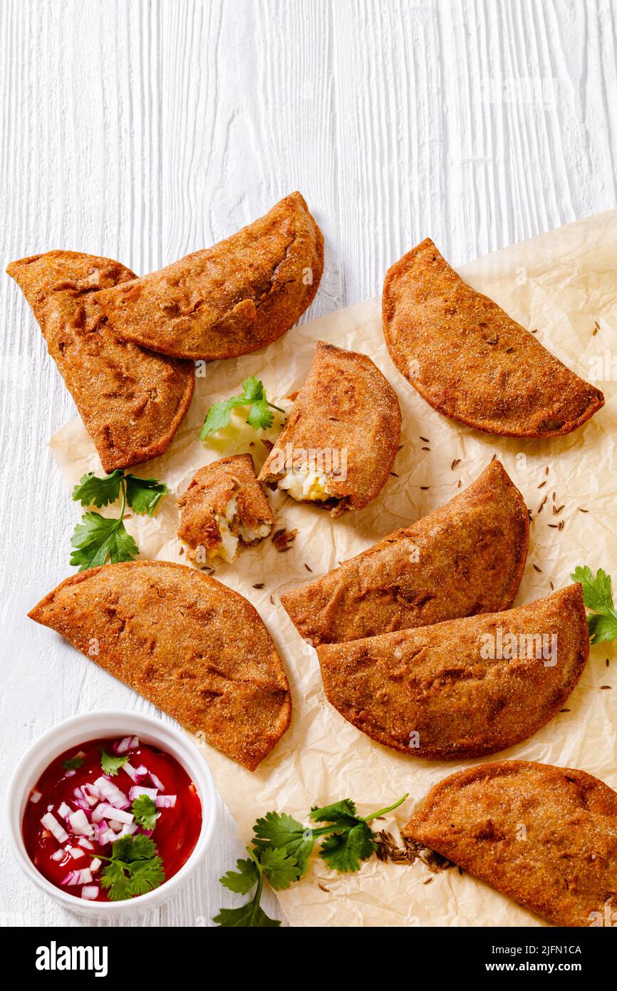 empanadas, pastry turnover with hard boiled egg fillings on parchment