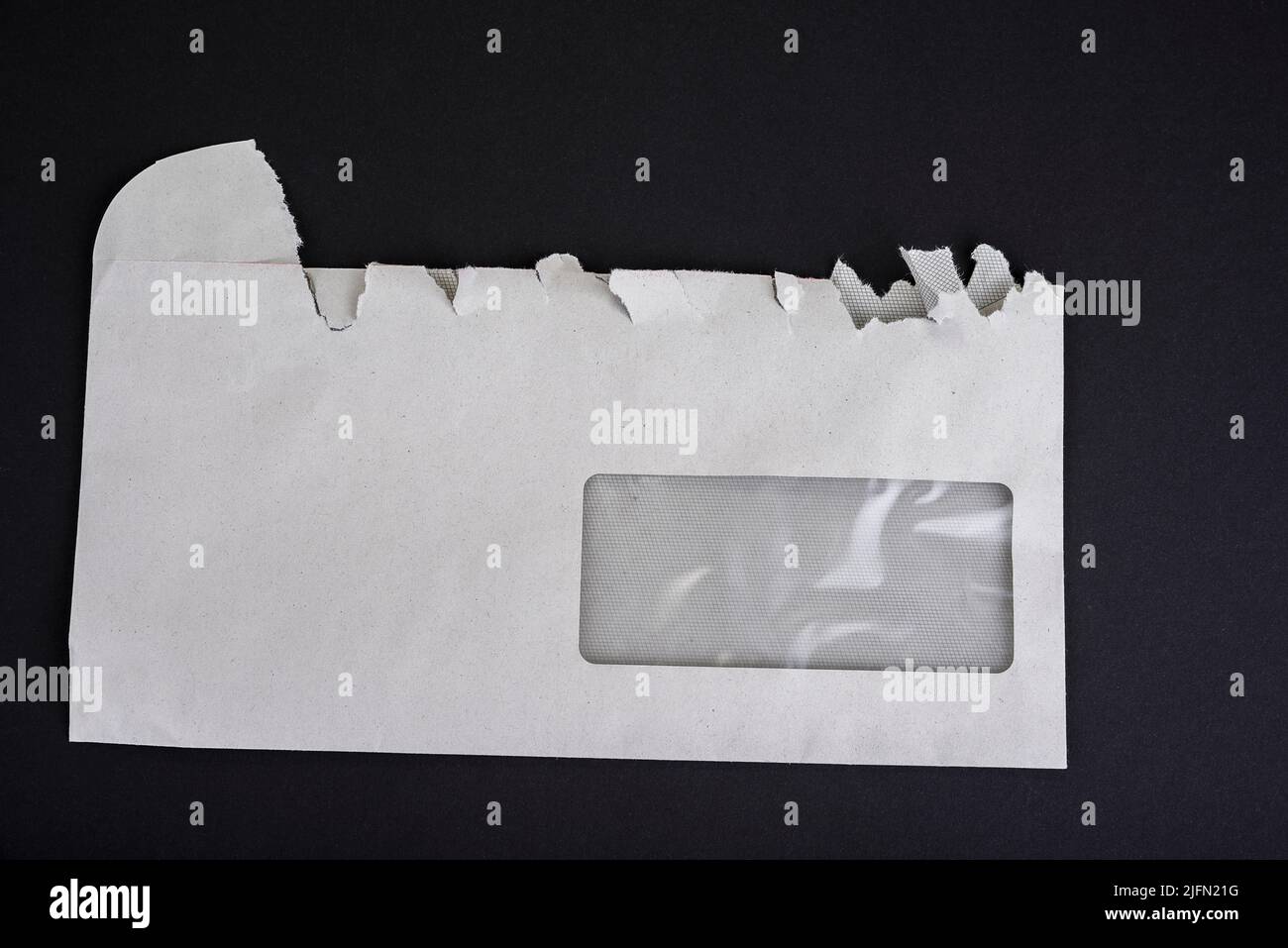 Sloppy opened envelope on a black background Stock Photo - Alamy