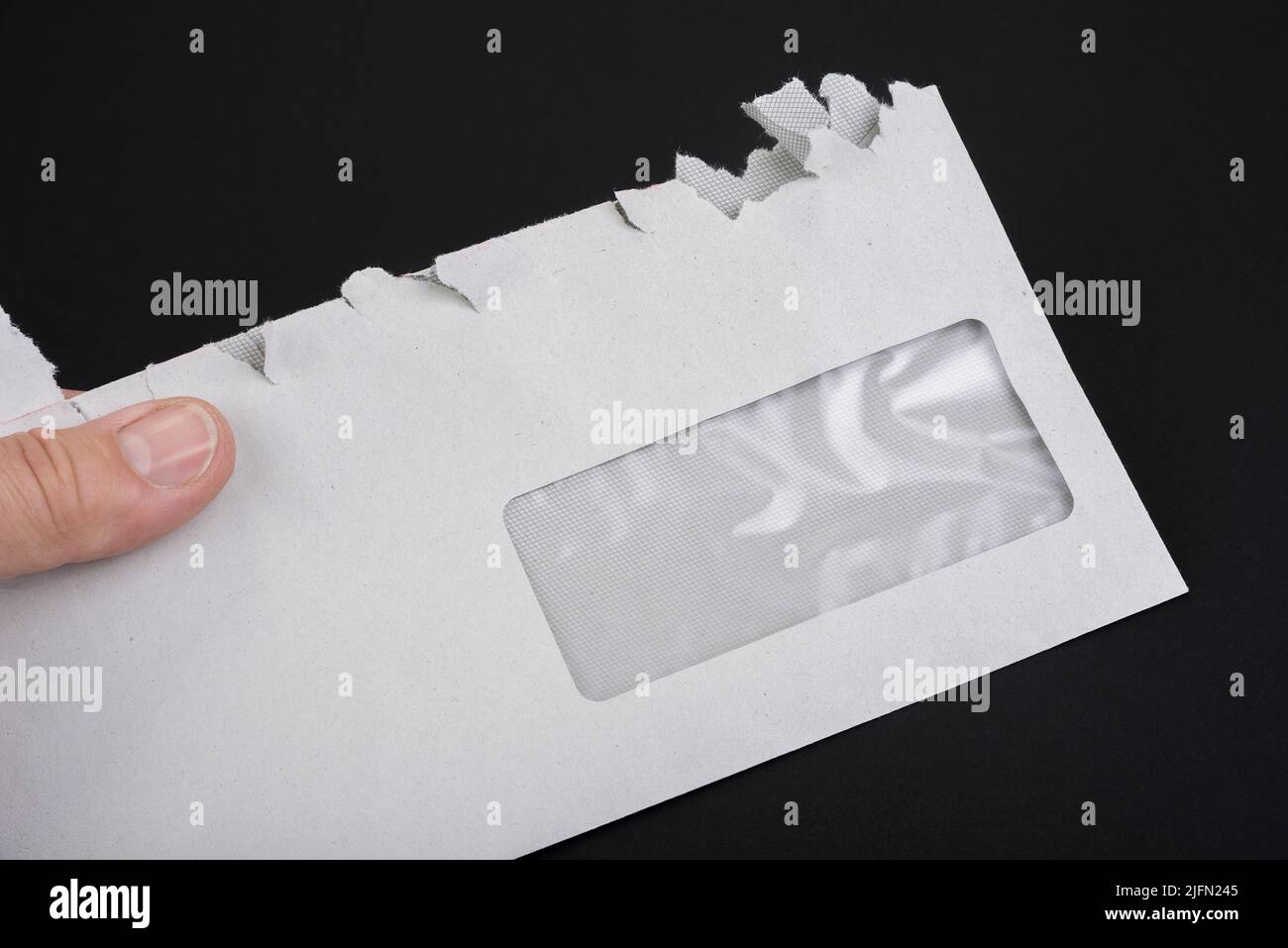 Sloppy opened envelope on a black background Stock Photo - Alamy