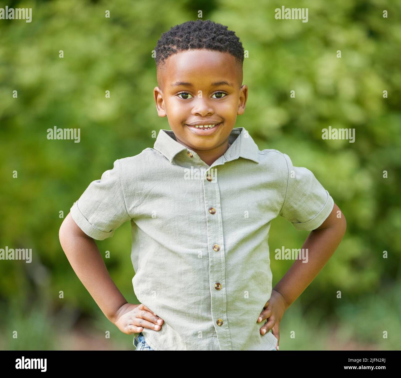 I love playing outside. Shot of an adorable little boy standing outside. Stock Photo