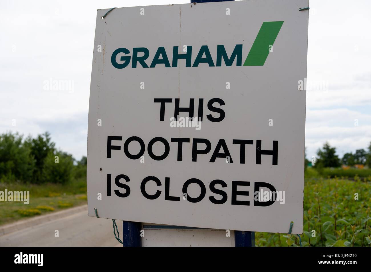 A sign from the UK construction company, Graham, notifies people that, 'This Footpath is Closed'. Stock Photo