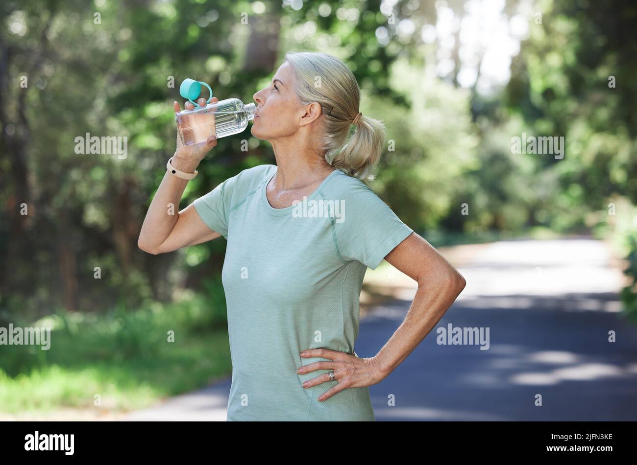 Stay hydrated or youll lose energy. Shot of a mature woman drinking