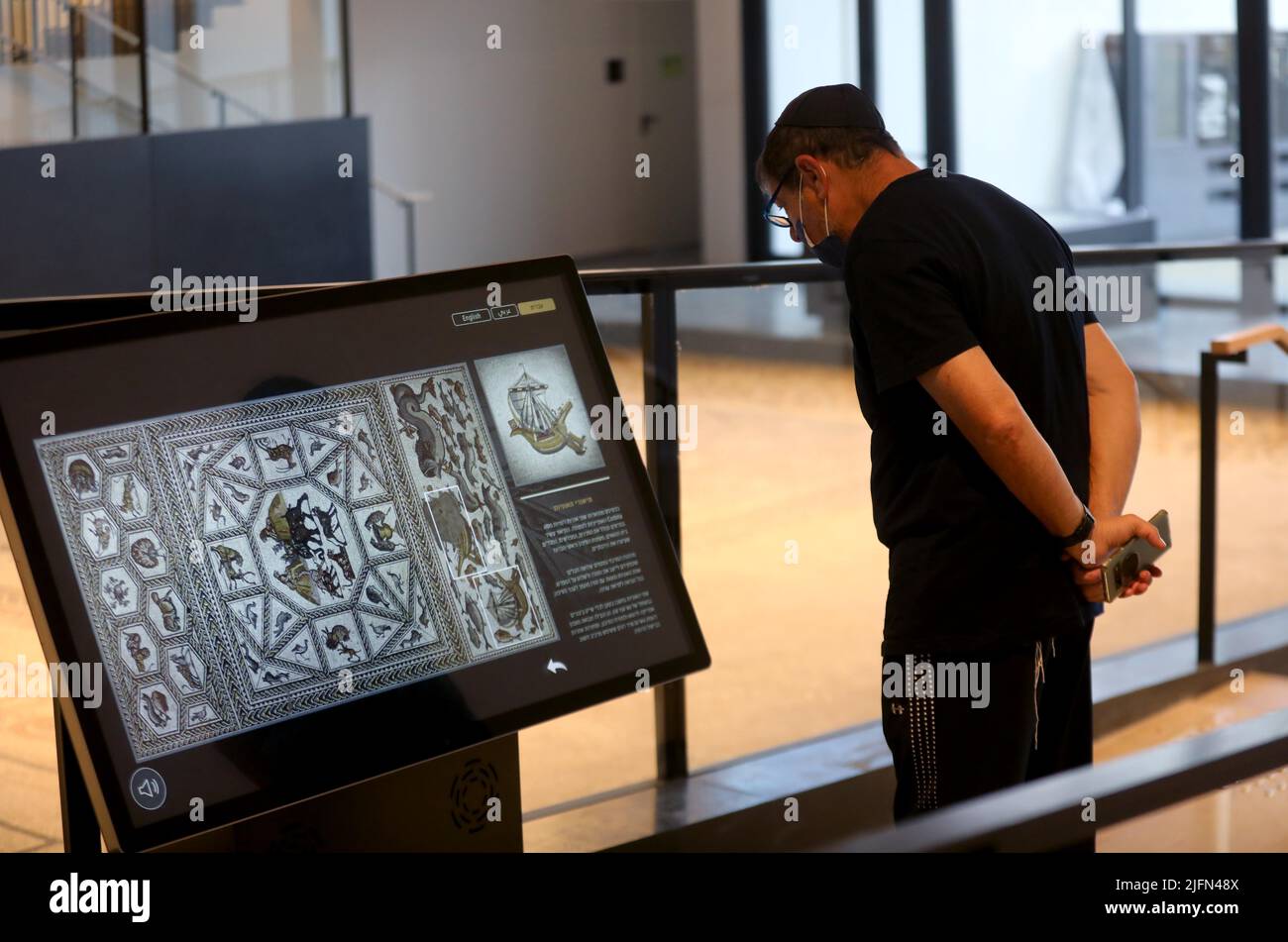 Lod, Tel Aviv in central Israel. 4th July, 2022. A man visits the Lod Mosaic Archaeological Center in Lod, a city east of Tel Aviv in central Israel, July 4, 2022. The Lod Mosaic Archaeological Center was built to exhibit the unique mosaics dating from the Roman period. Credit: Gil Cohen Magen/Xinhua/Alamy Live News Stock Photo