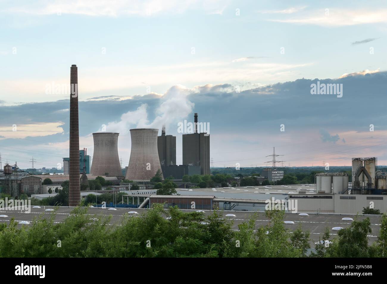 Chimney and cooling towers with pollution, steel production industry in Duisburg with blast furnaces, coke oven and power plant, industrial landscape Stock Photo