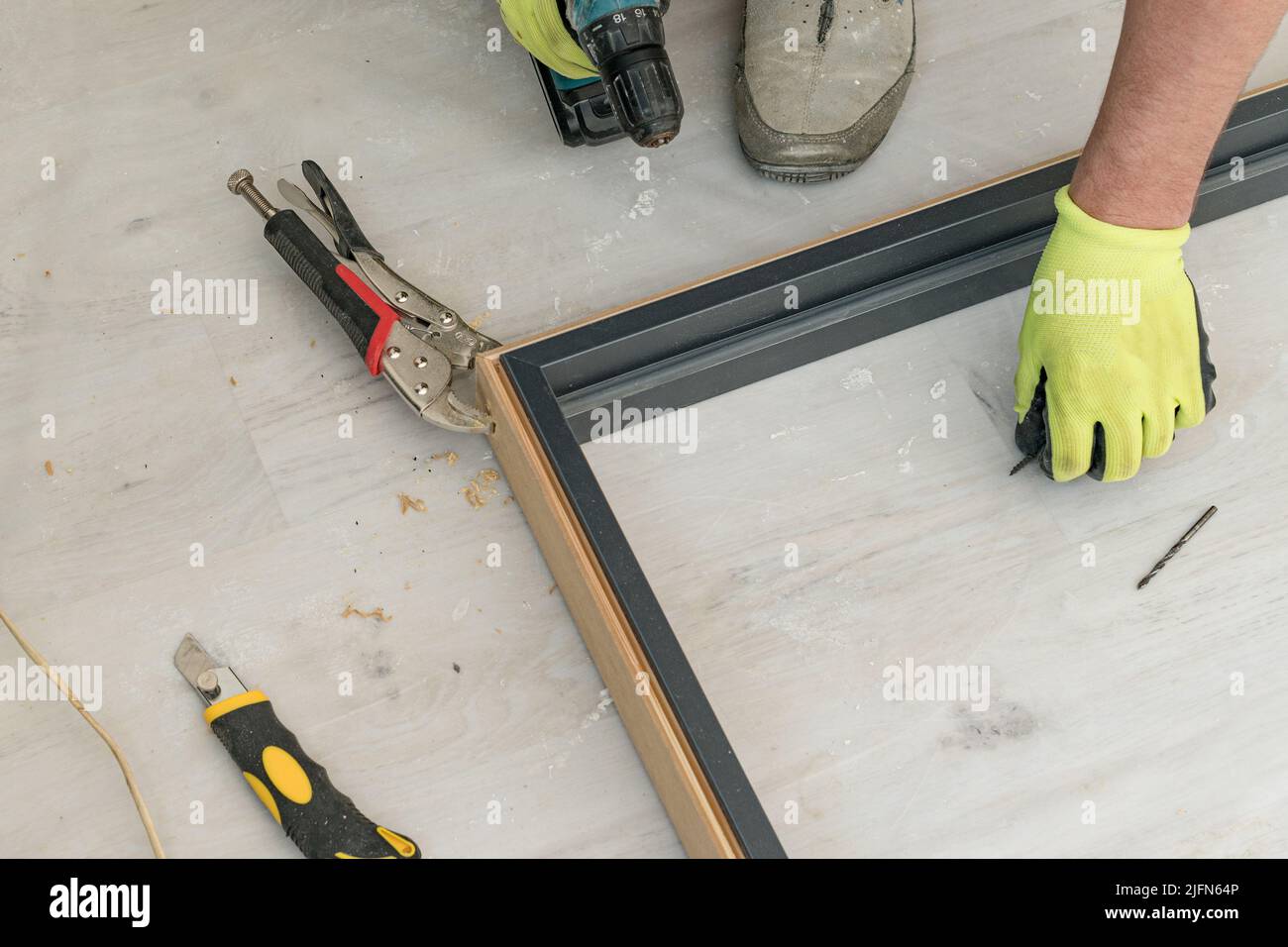 Drilling a hole in the door frame for a corner connection, installation of interior doors Stock