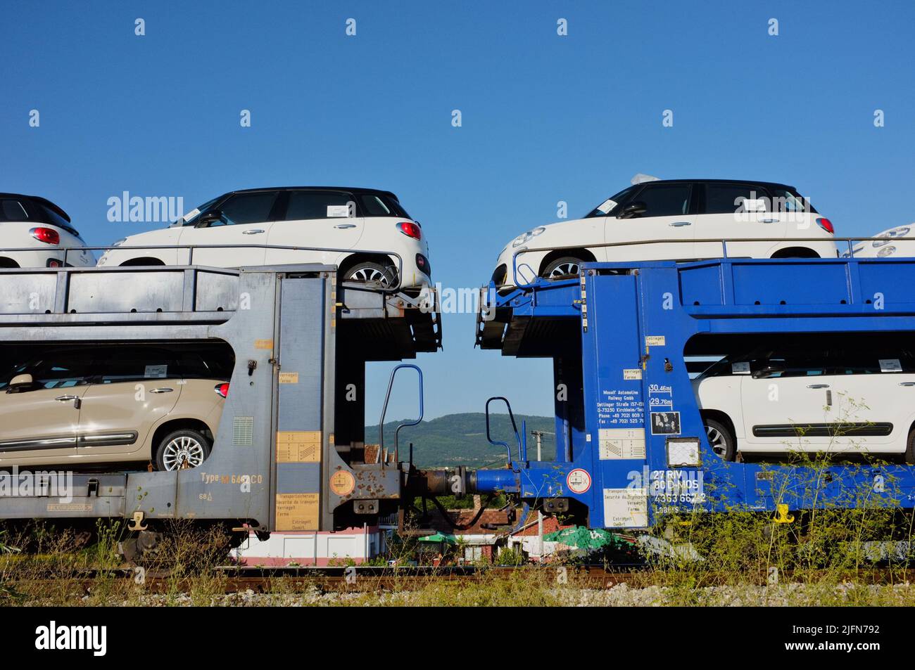 new cars, Fiat 500L, on a freight train of Mosolf automotive business, logistics and services, in Serbia Stock Photo
