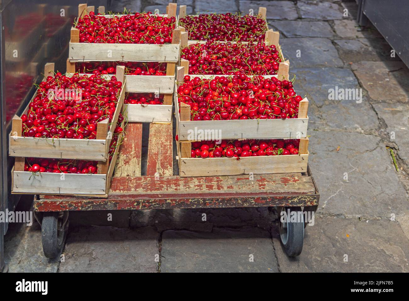 Fresh Sweet Red Cherry Fruits in Carts at Crate Delivery Stock Photo