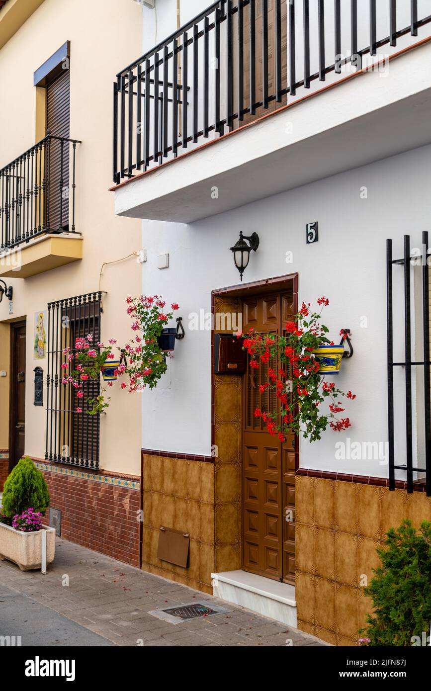 Streets of city of Alhaurin de la Tore, situated in south of Spain in Malaga province. Typically Andalusian small streets with white houses and flower Stock Photo