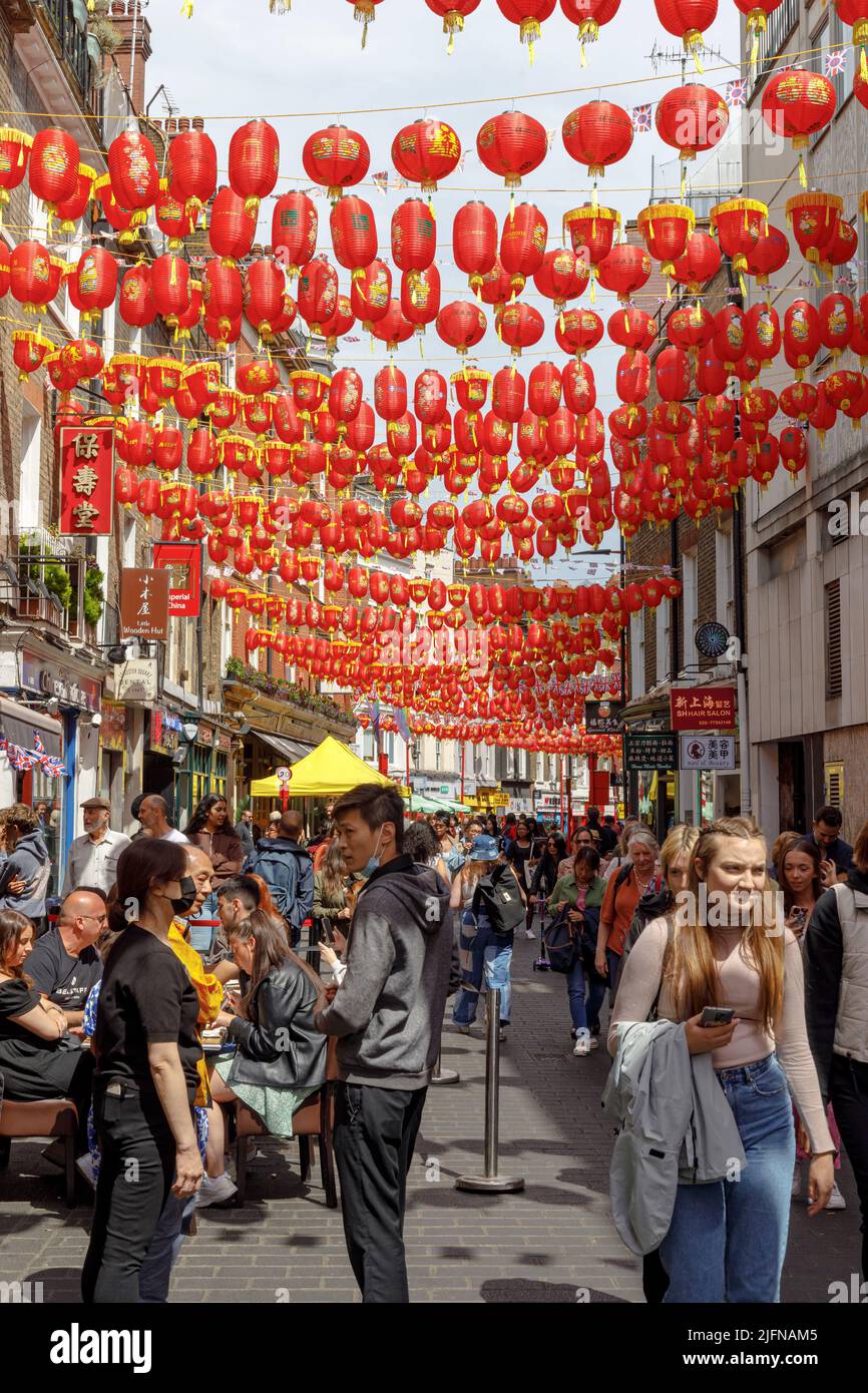 Red lanterns hang on Lisle Street in Chinatown, London, UK Stock Photo