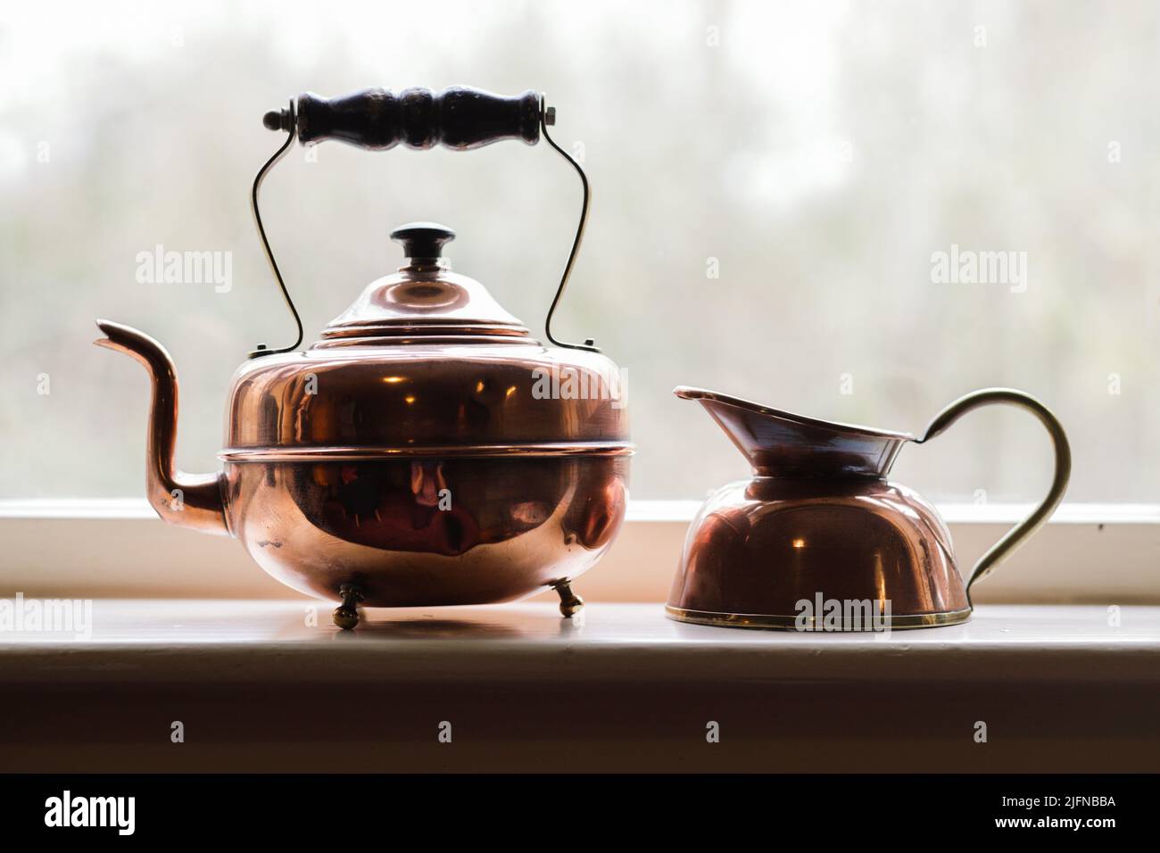An old brown kettle on the side of the window Stock Photo Alamy
