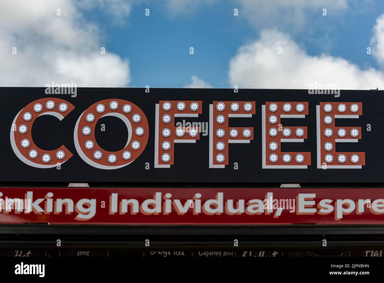 An LED Coffee sign above a drinks vending unit. Stock Photo