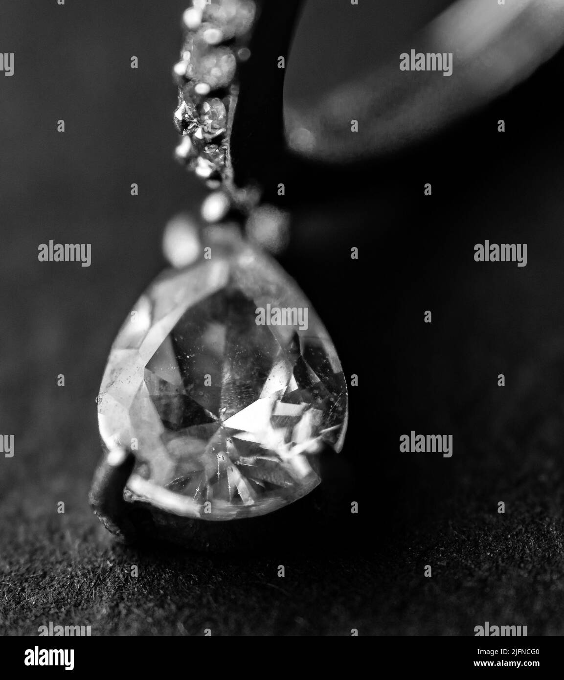 A vertical grayscale shot of a diamond necklace Stock Photo