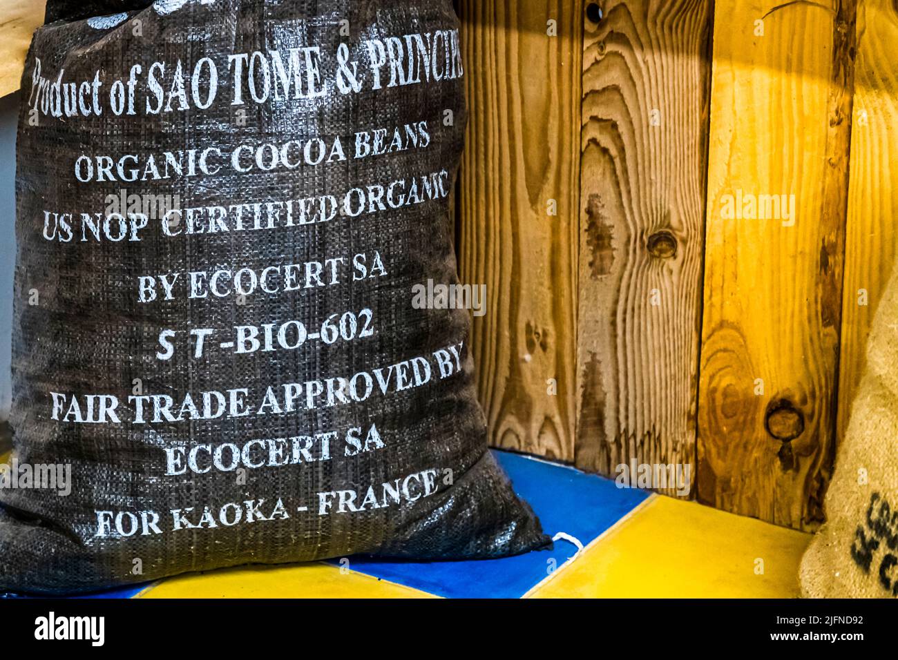Bag of cocoa beans from São Tomé & Principe. The island nation in the Gulf of Guinea also bears the name Chocolate Island. In 1822, Portuguese settlers from Brazil settled on São Tomé & Principe. They also brought cocoa plants with them. The aromas of the Grand Cru cocoa bean from Sao Toné are described by company founder Bernard Xueref with notes of cinnamon, caramel and tobacco, slightly floral and a little acidic. Stock Photo