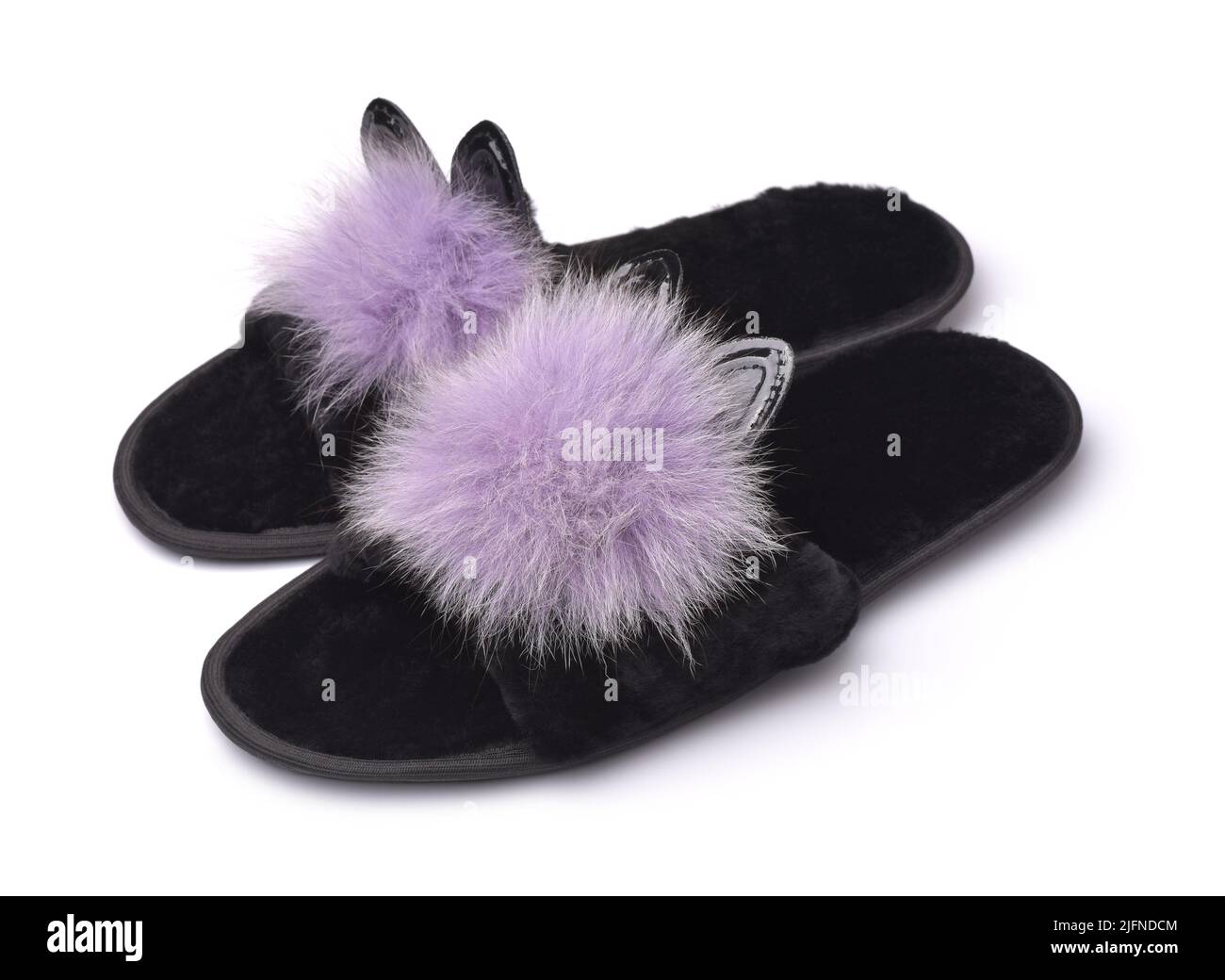 Pair of soft fluffy black slippers with pompoms and ears isolated on white Stock Photo