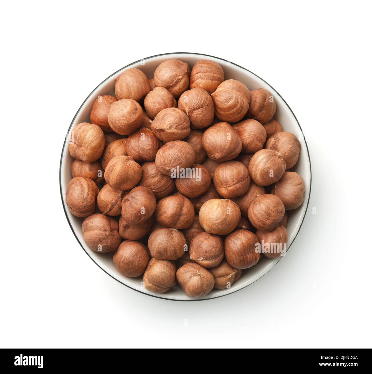 Top view of shelled hazelnut kernels in ceramic bowl isolated on white Stock Photo