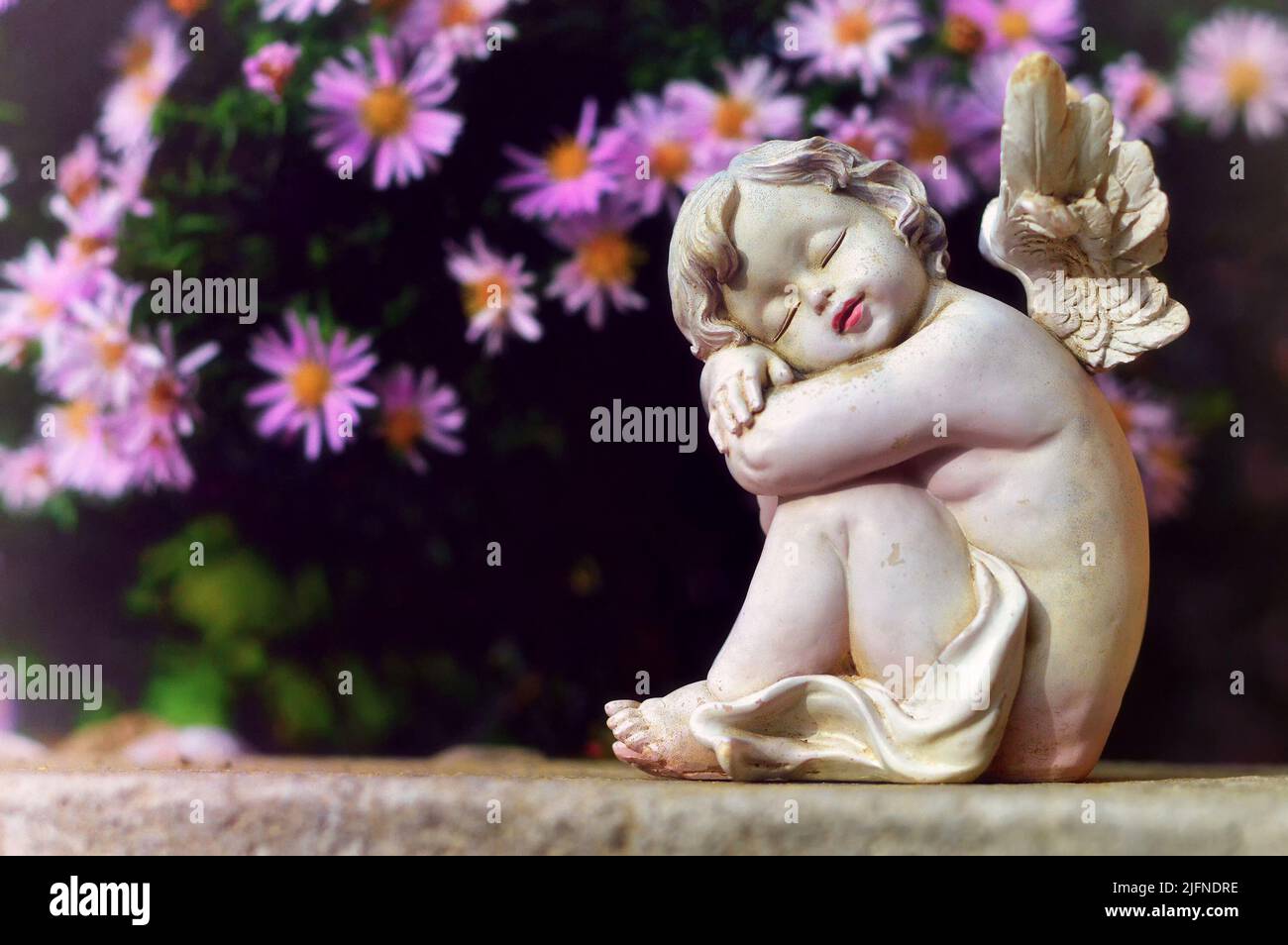 Guardian angel and pink flowers Stock Photo