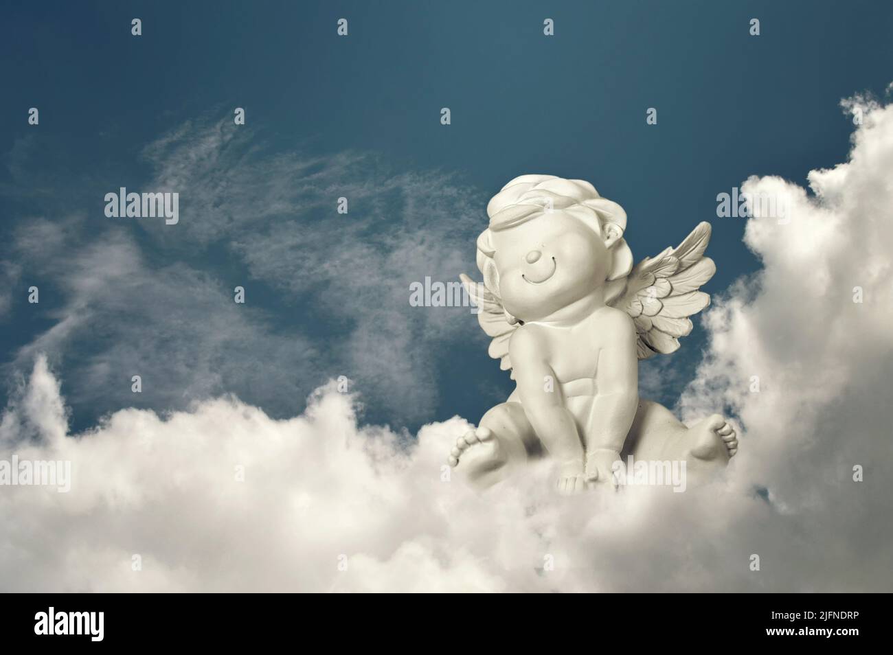 Guardian angel sitting on the cloud Stock Photo