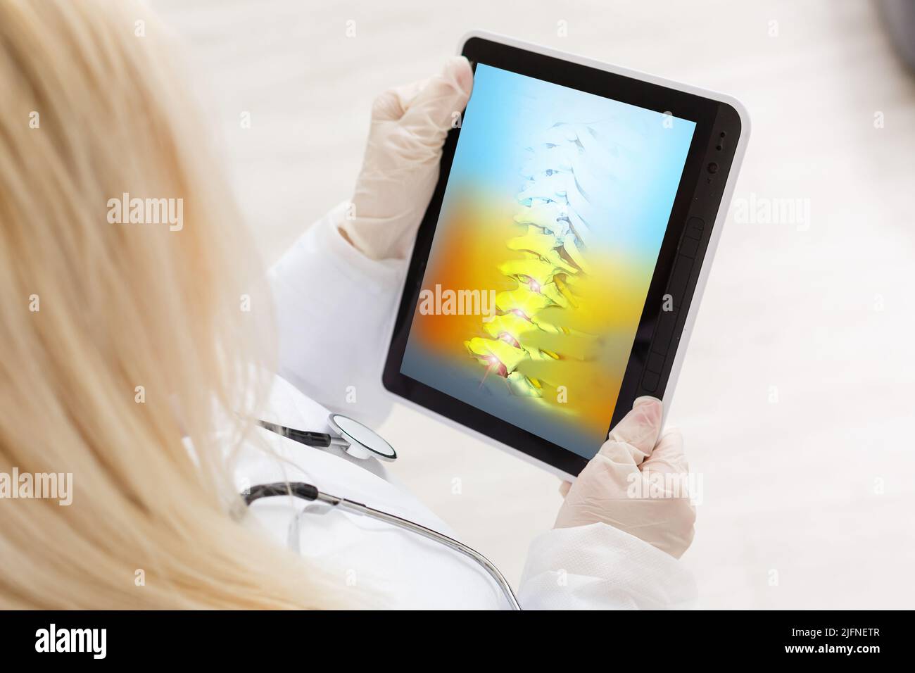 Doctor watching a xray of hips and spine for back pain on digital tablet Stock Photo Alamy