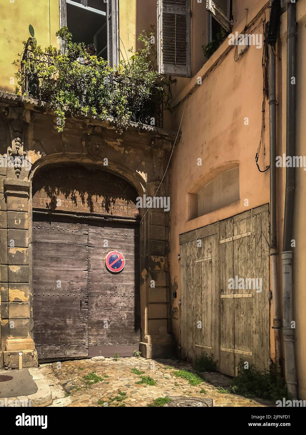 Aix-en-Provence, France, May 2022, view of closed wooden doors  in Littera Street Stock Photo