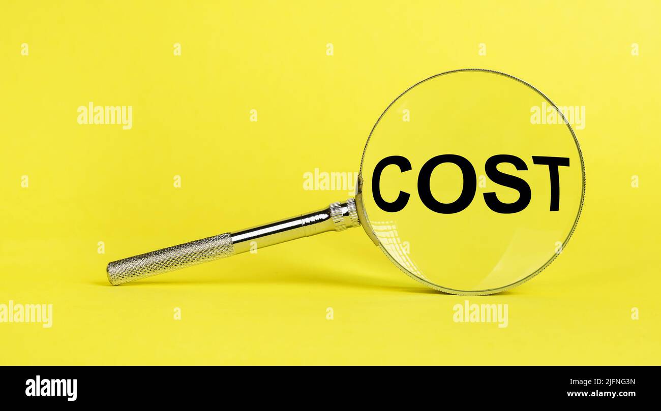 cost word through magnifying lens. High quality photo Stock Photo Alamy
