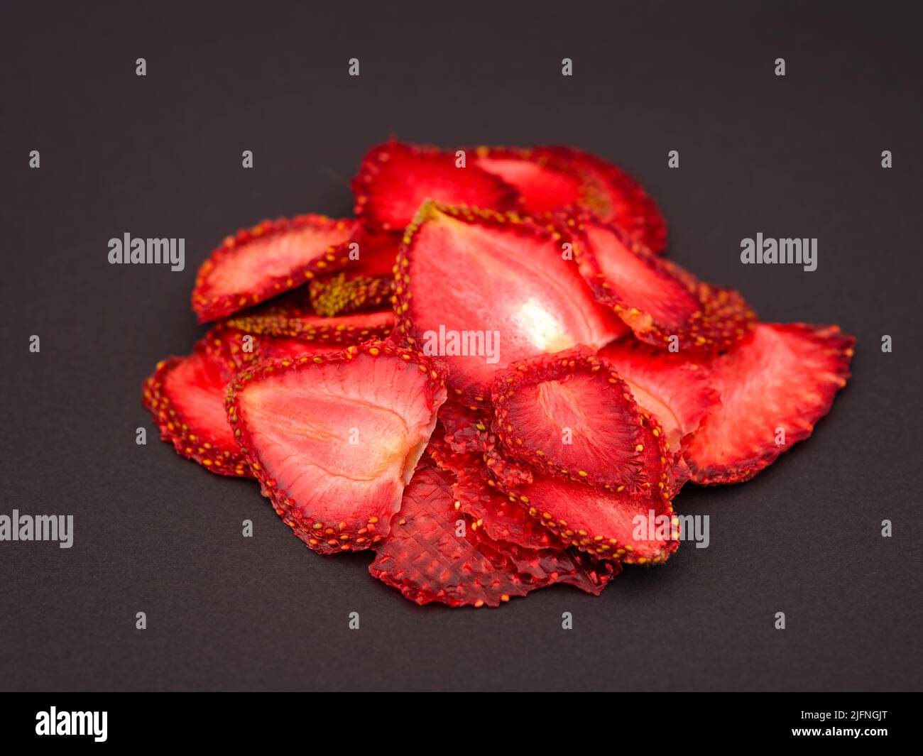 Dried strawberry slices on a black background Stock Photo