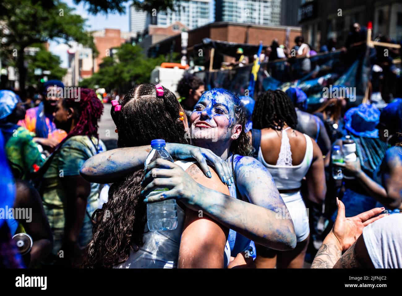 Two revelers are hugging behind the main float during the parade Stock ...