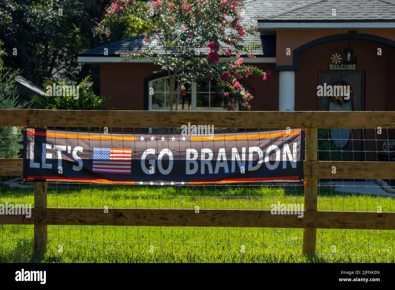 Let's Go Brandon sign on the fence of a Florida home. Stock Photo