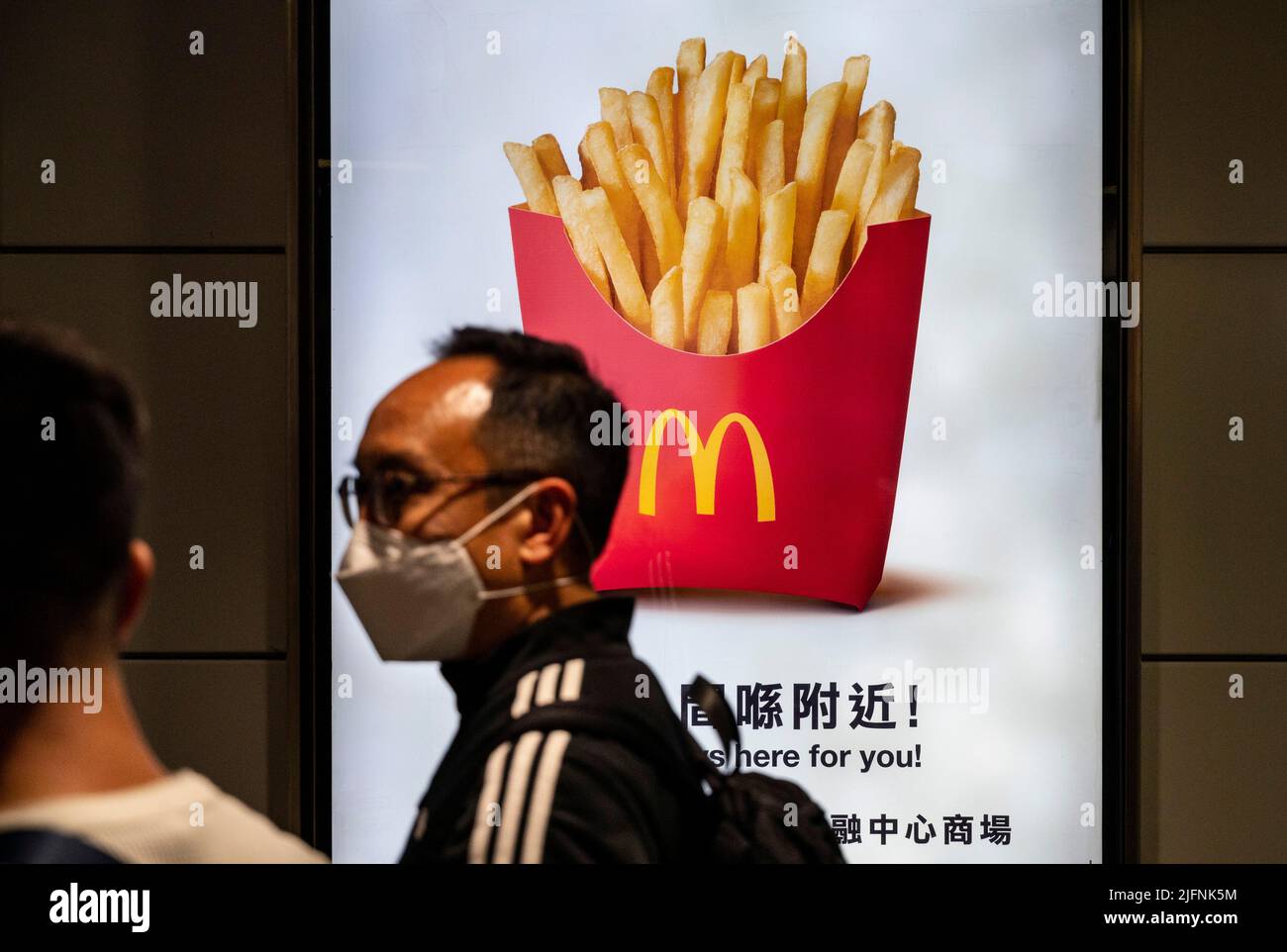 Hong Kong, China. 28th Jan, 2022. A pedestrian walks past a McDonald's commercial advertisement in Hong Kong. (Credit Image: © Budrul Chukrut/SOPA Images via ZUMA Press Wire) Stock Photo
