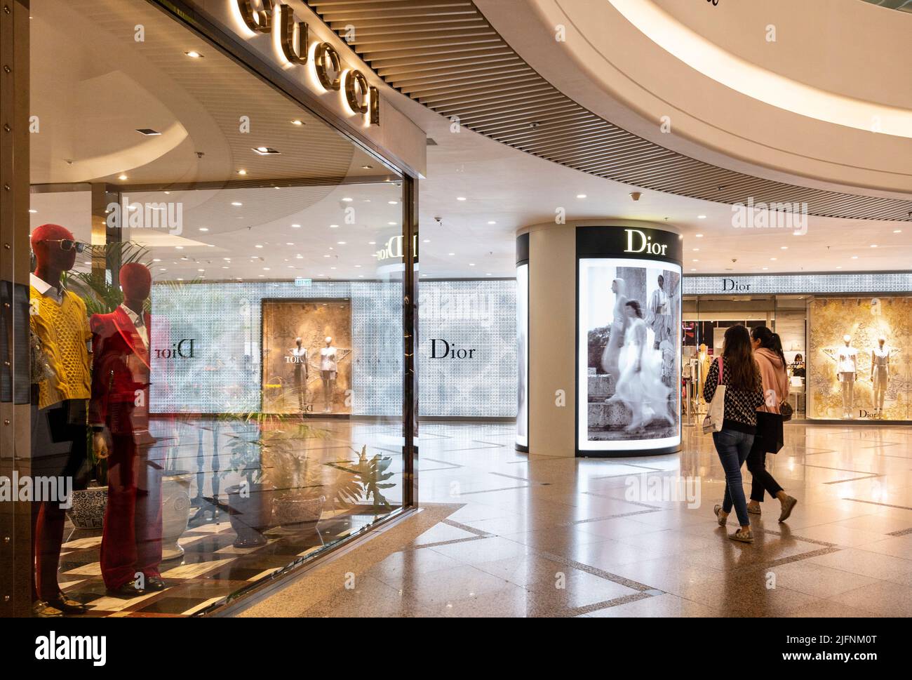 Hong Kong, China. 25th Nov, 2021. Shoppers walk past the Italian and French luxury fashion brands Gucci and Dior stores in Hong Kong (Credit Image: © Budrul Chukrut/SOPA Images via ZUMA Press Wire) Stock Photo