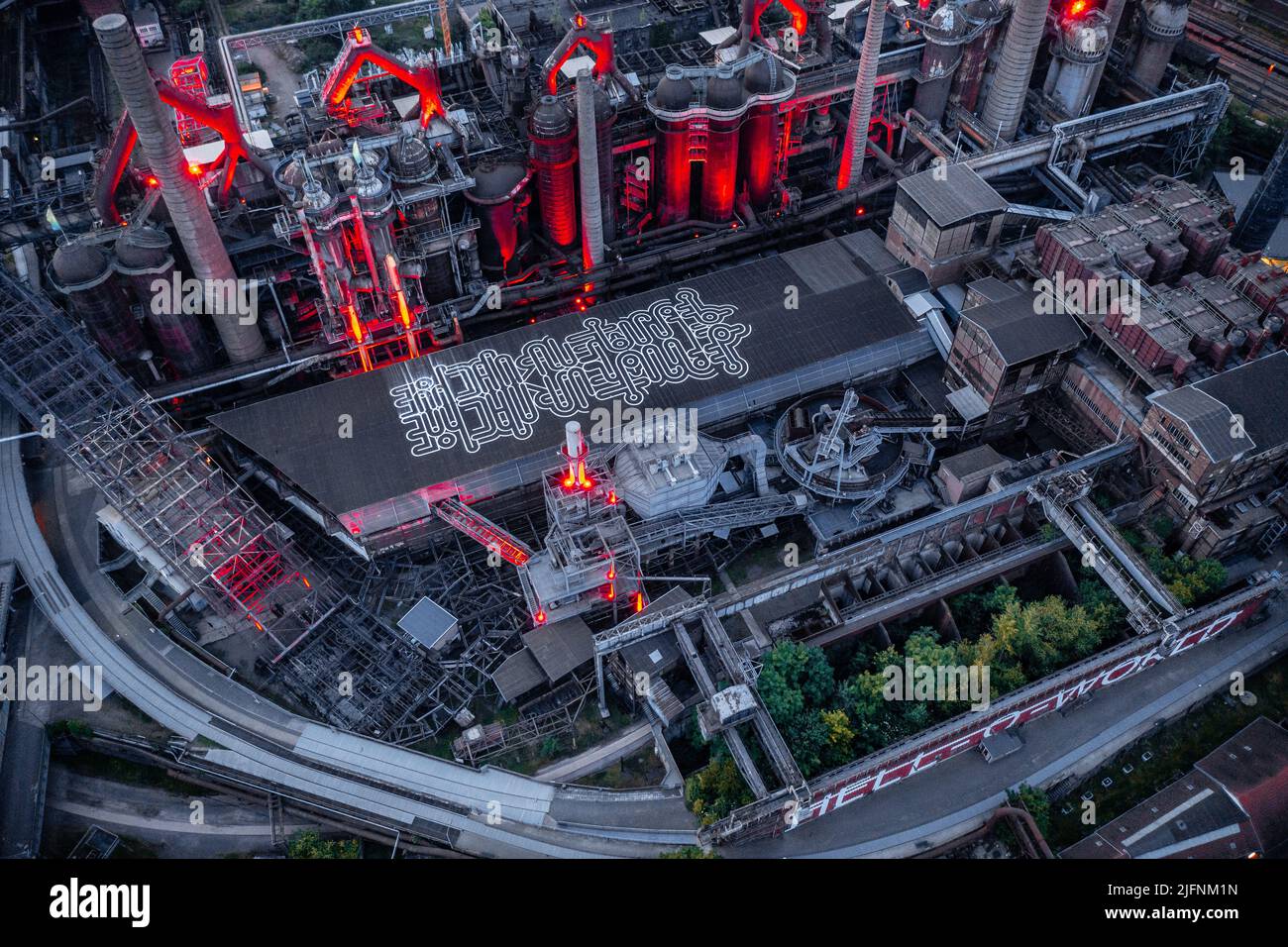 Aerial view of the Voelklingen Ironworks Unesco World Heritage Site red  with the night red lighting Stock Photo