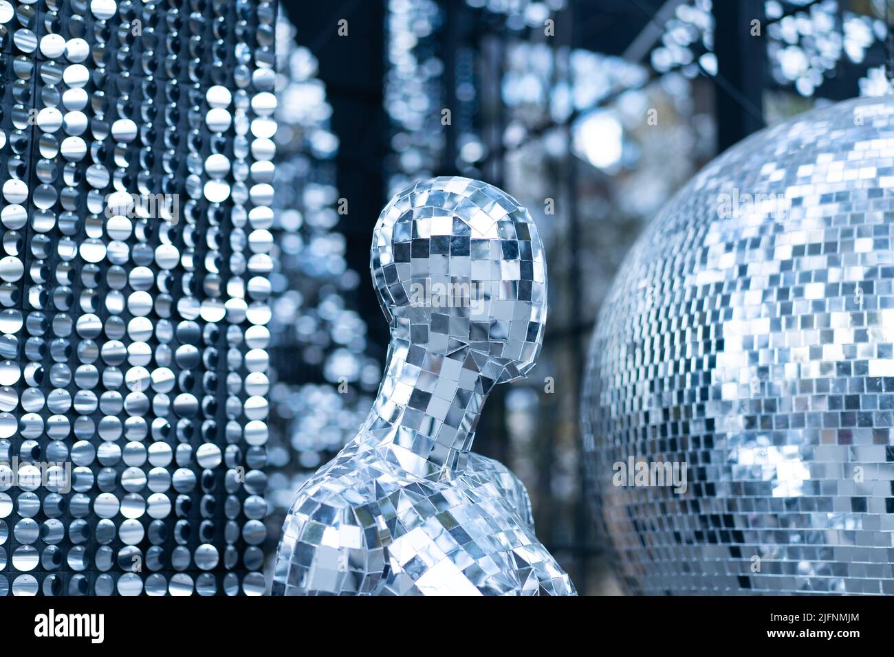 Male mannequin covered with slices of a mirror on a black background mr