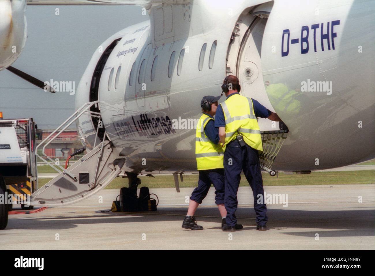 London City Airport ground crew preparing airplanes for flight on the gate. Stock Photo