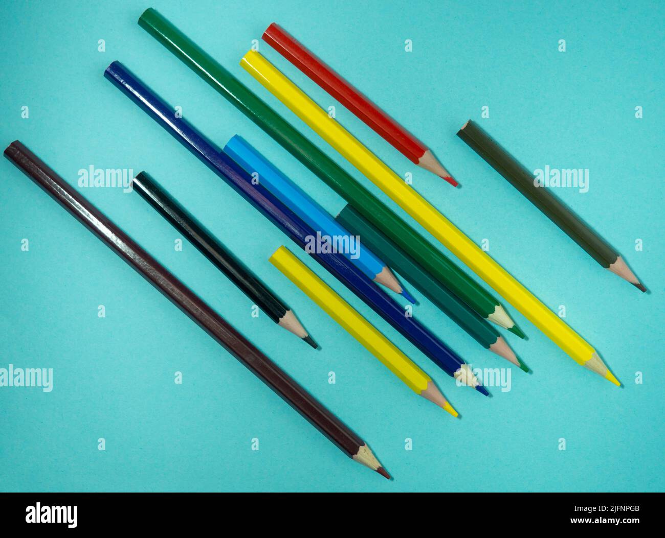 Colored wooden pencils on colored paper. Sharpened pencils. Drawing