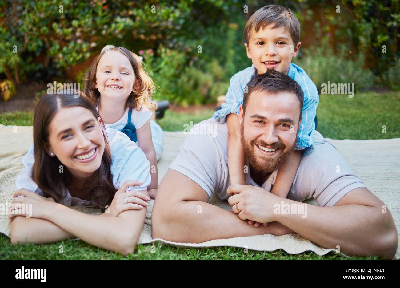 Family with two children lying on grass hi-res stock photography and ...