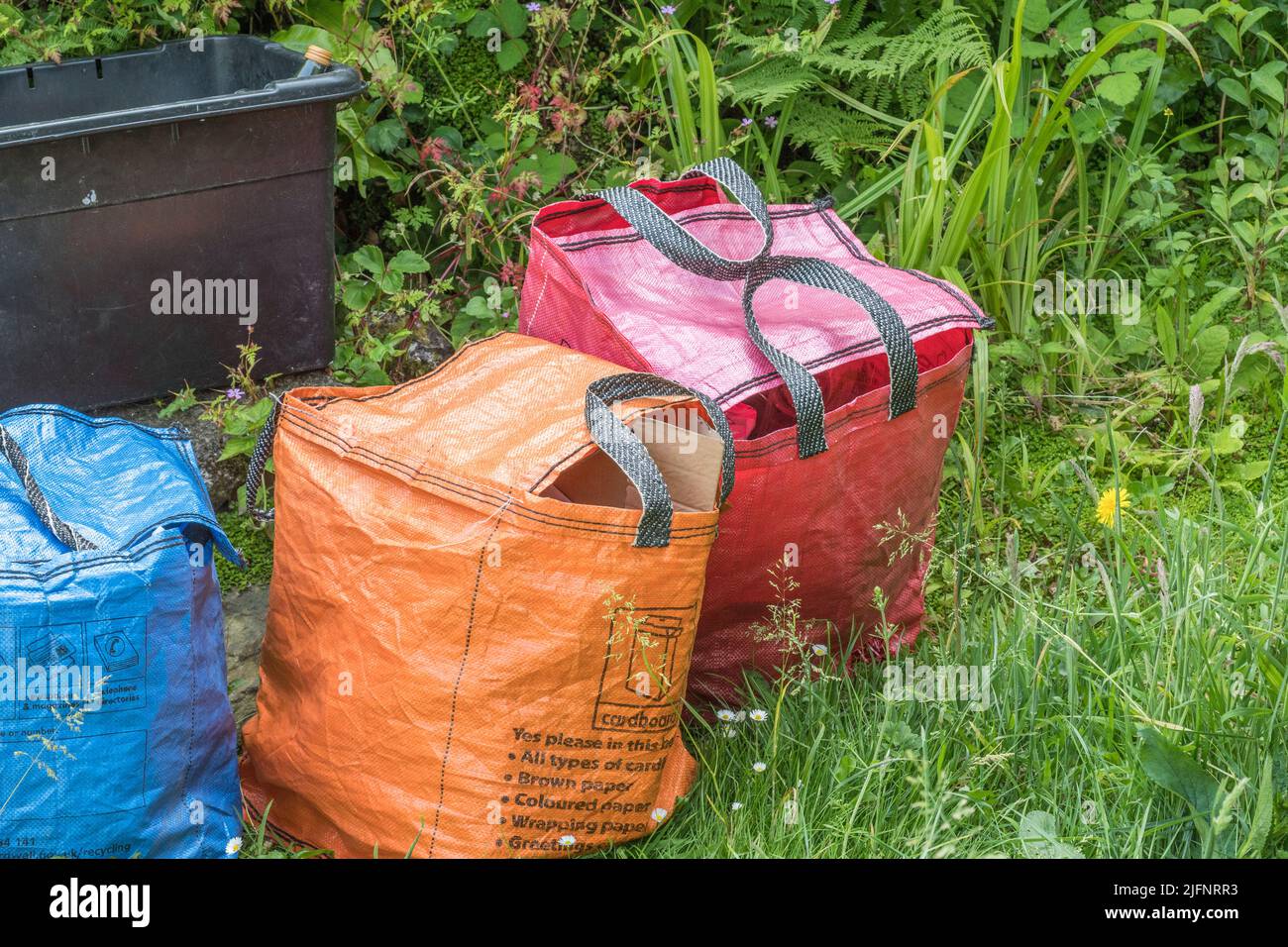 Pile of weekly domestic rubbish outside rural house awaiting refuse