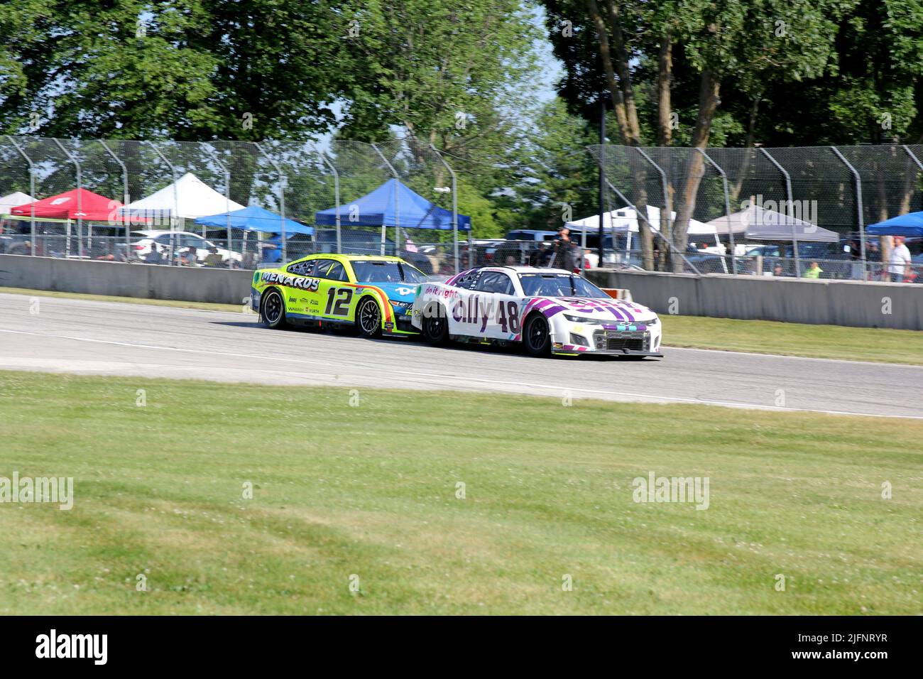 Elkhart Lake, Wisconsin - 3 July 2022: Kwik Trip 250 presented by JOCKEY Made in America. Alex Bowman No. 48 Hendrick Motorsports narrowly leads Ryan Stock Photo