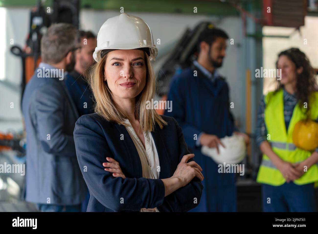 Inform Chief Engineer Portrait of female chief engineer in modern industrial factory looking ...