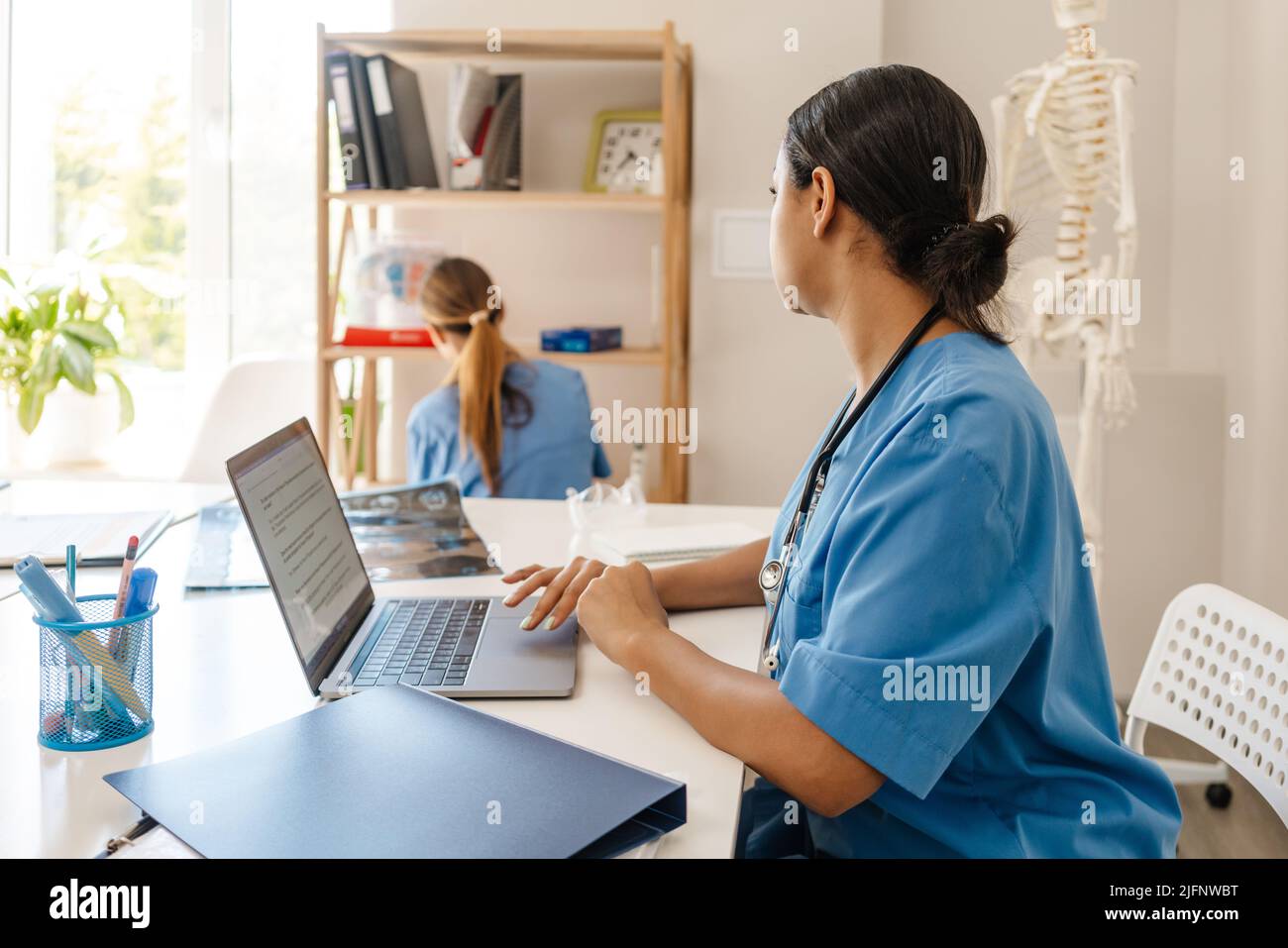Multiracial women doctors working together in office indoors Stock ...