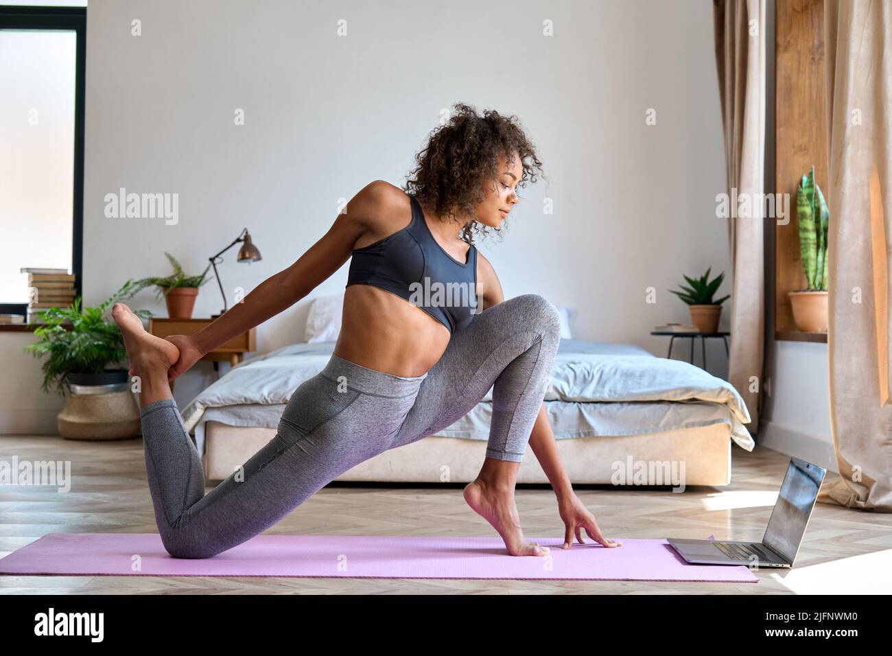 Fitness. Woman Doing Workout Exercise On Street. Beautiful Fit Girl Wearing  Fitness Tracker, Headphones And Armband Phone Case Stretching Her Long Legs  Outdoors. Sports Devices. High Resolution Stock Photo, Picture and Royalty