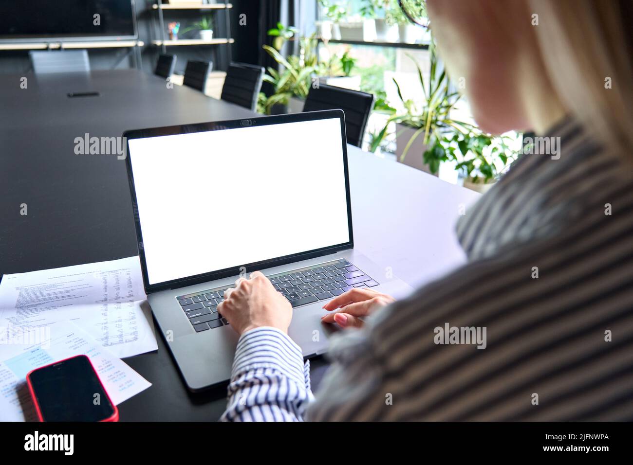 Young manager ceo typing on laptop computer keyboard with blank screen. Stock Photo