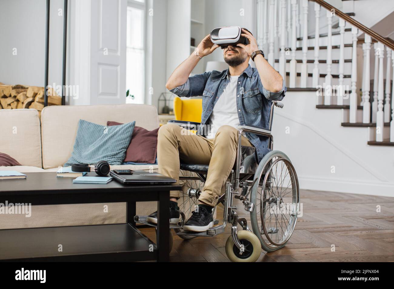 Disabled man watching virtual video using goggles of augmented reality