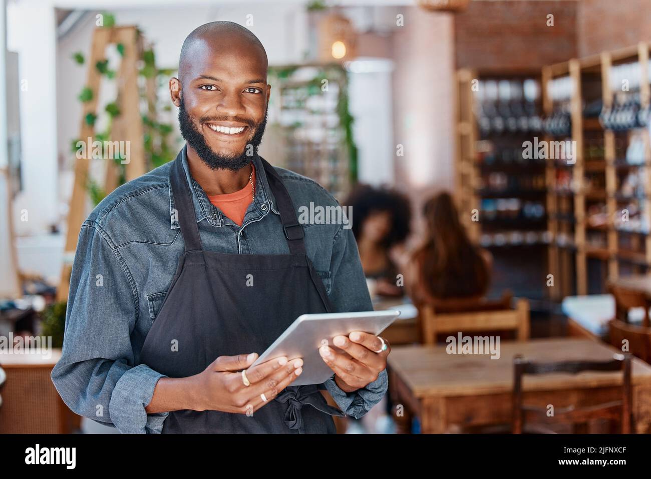 Young african american businessman working in a retail store using a