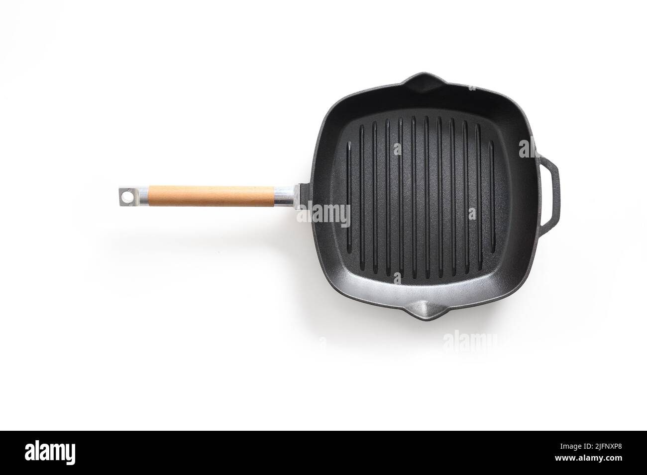 Empty cast iron grill pan with handle isolated on white background. Stock Photo