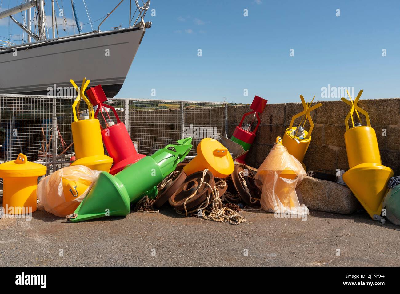 Penzance Harbour, Cornwall, England, UK. 2022. Colourfull selection of plastic buoys for mooring navigation and navigation on the harbour wall. Penzan Stock Photo