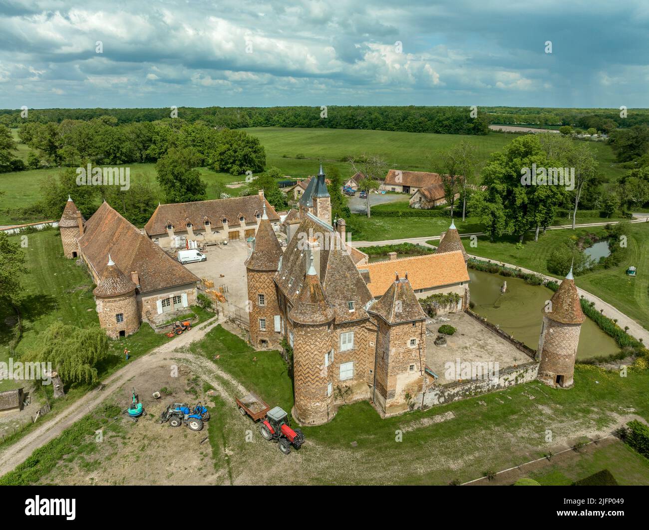 Aerial view of Chateau de la Cour-en-Chapeau in Allier France constructed with black diamond-shaped bricks on a background of red bricks, palace, gate Stock Photo